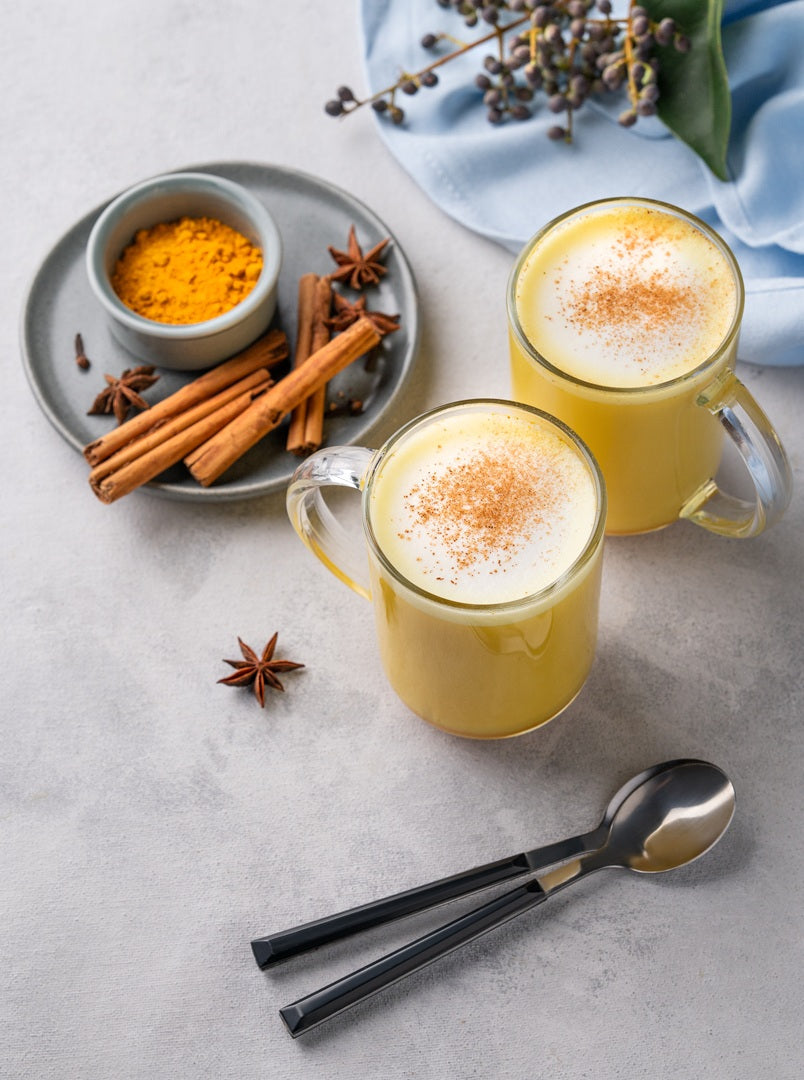 Golden milk latte with cinnamon and turmeric spices – warm anti-inflammatory drink recipe using Ceylon cinnamon