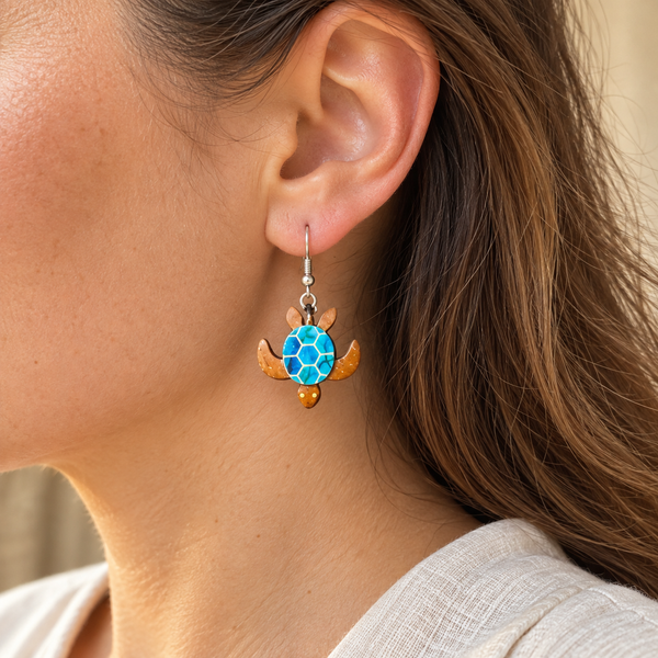Blue Sea Turtle Coconut Shell Dangle Earrings, worn by an adult woman