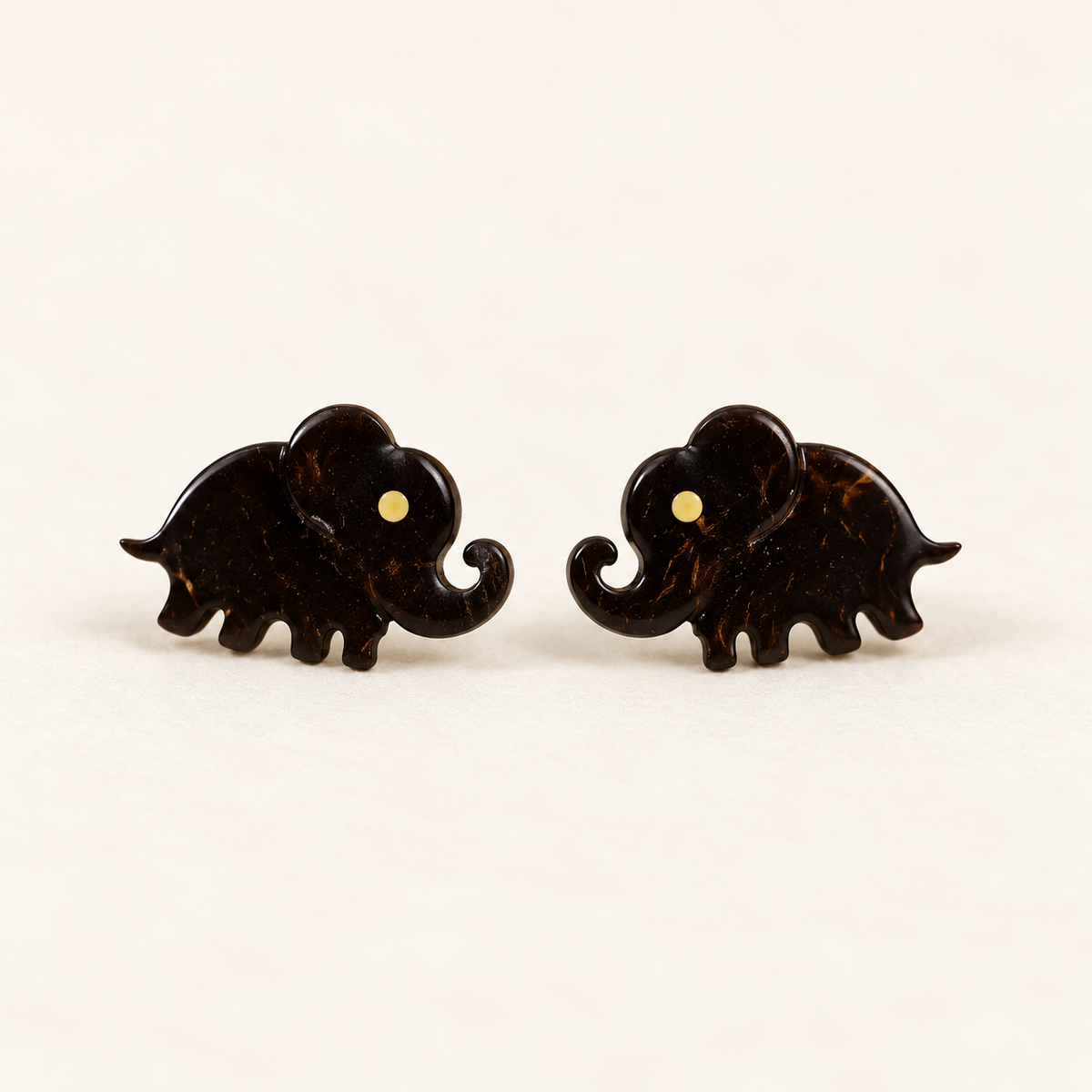 Brown Elephant Silhouette Stud Earrings, pair on a clean ivory studio background
