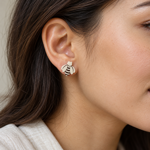 Ivory Bee Stud Earrings, worn by an adult woman