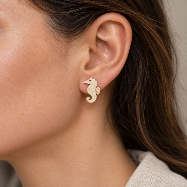 Ivory Seahorse Stud Earrings, worn by an adult woman