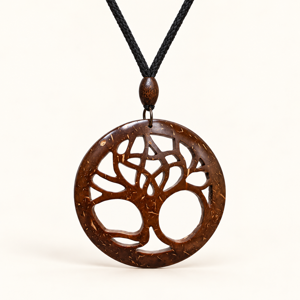 Openwork Tree of Life Coconut Shell Necklace, studio view showing pendant, bead and black cord on an ivory background
