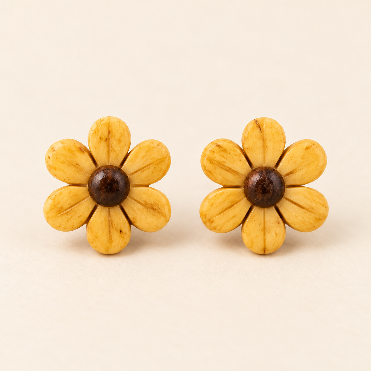 Yellow Daisy Flower Stud Earrings, matching studio pair on an ivory background
