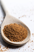 Ceylon cinnamon powder served with a wooden spoon – premium single origin spice